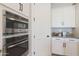 Kitchen with built-in stainless steel microwave and oven appliances next to white cabinets at 14979 S 184Th Ave, Goodyear, AZ 85338