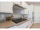 Modern kitchen featuring white cabinets, stainless steel appliances, and built-in gas cooktop at 14979 S 184Th Ave, Goodyear, AZ 85338