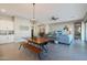 Open-concept dining and living area with comfortable seating, lots of natural light and tile floors at 14979 S 184Th Ave, Goodyear, AZ 85338