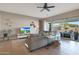 Bright living room with neutral tones, tile flooring, and access to outdoor patio area at 14979 S 184Th Ave, Goodyear, AZ 85338