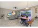 Open-concept living and dining area with sliding glass doors to backyard and view of a pool at 14979 S 184Th Ave, Goodyear, AZ 85338
