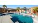 Sparkling pool with swim up seating and outdoor kitchen area at 14979 S 184Th Ave, Goodyear, AZ 85338