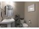 This powder room offers a pedestal sink, bronze fixtures, and charming decorative details at 14979 S 184Th Ave, Goodyear, AZ 85338