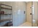 The frameless glass shower showcases sleek gray tiles and integrated shelving at 14979 S 184Th Ave, Goodyear, AZ 85338