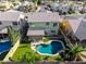 Aerial view of home and backyard with pool, manicured lawn, covered patio and lush landscaping at 1560 E Flint St, Chandler, AZ 85225