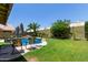 Lush backyard with a gorgeous pool, rock features, seating, and landscaping, creating a private oasis at 1560 E Flint St, Chandler, AZ 85225