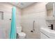 Modern bathroom with tiled walls, grab bar, a sleek vanity, and a shower with a curtain at 1560 E Flint St, Chandler, AZ 85225