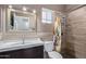 Bathroom featuring wood look tiling and a stylish vanity with a large, decorative mirror at 1560 E Flint St, Chandler, AZ 85225