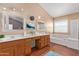 Bright bathroom featuring double sinks, wood cabinets, and soaking tub at 1560 E Flint St, Chandler, AZ 85225