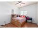 Bedroom features wood floors, ceiling fan, and built-in headboard and drawers at 1560 E Flint St, Chandler, AZ 85225