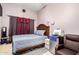 Small bedroom featuring a bed, mini fridge, and wood-look flooring at 1560 E Flint St, Chandler, AZ 85225