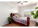 Bedroom features wood floors, window, ceiling fan, and neutral wall color at 1560 E Flint St, Chandler, AZ 85225