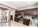 A well-lit kitchen showcases dark wood cabinets, stainless steel appliances, and stylish countertops, seamlessly blending style at 1560 E Flint St, Chandler, AZ 85225