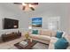Cozy living room with a large sectional sofa, modern entertainment center, and bright natural light at 1560 E Flint St, Chandler, AZ 85225