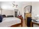 Spacious main bedroom with wood floors and ceiling fan, view into sitting room at 1560 E Flint St, Chandler, AZ 85225