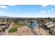 An aerial shot of a golf course community, highlighting mature trees, green grass and ponds at 15774 W Indianola Dr # Six, Goodyear, AZ 85395