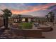 Inviting backyard featuring a cozy seating area, mature trees, and a custom concrete wall at 15774 W Indianola Dr # Six, Goodyear, AZ 85395