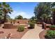 Private backyard features desert landscaping, a walkway and mature palm trees at 15774 W Indianola Dr # Six, Goodyear, AZ 85395