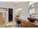 Bathroom offers granite counters, double sink with bronze faucets, and walk-in closet at 15774 W Indianola Dr # Six, Goodyear, AZ 85395