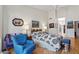 Sunlit bedroom boasts wood floors, vibrant blue chair, and coordinated artwork at 15774 W Indianola Dr # Six, Goodyear, AZ 85395