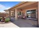 This covered patio features a ceiling fan and easy access to the backyard and outdoor kitchen at 15774 W Indianola Dr # Six, Goodyear, AZ 85395