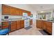 Traditional kitchen with wood cabinets, granite counters, and tile flooring offers a cozy cooking space at 15774 W Indianola Dr # Six, Goodyear, AZ 85395