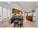 Bright kitchen featuring wood cabinets, tile floors, granite countertops, and a charming breakfast nook at 15774 W Indianola Dr # Six, Goodyear, AZ 85395