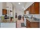 Spacious kitchen features wood cabinets, granite countertops, and ample natural light for delightful cooking at 15774 W Indianola Dr # Six, Goodyear, AZ 85395