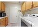 Functional laundry room with washer, dryer, and storage cabinets at 15774 W Indianola Dr # Six, Goodyear, AZ 85395