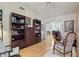 Cozy living room with hardwood floors, arched doorway, and decorative bookshelves at 15774 W Indianola Dr # Six, Goodyear, AZ 85395