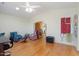 Inviting living room with hardwood floors, ceiling fan, and arched doorway at 15774 W Indianola Dr # Six, Goodyear, AZ 85395