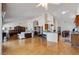 Expansive living area with wood floors flows into kitchen, creating ideal space for entertaining and relaxation at 15774 W Indianola Dr # Six, Goodyear, AZ 85395