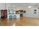 Open living space with wood floors seamlessly connects to the kitchen, perfect for modern living at 15774 W Indianola Dr # Six, Goodyear, AZ 85395