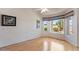 Sunlit living space with hardwood floors, large windows, and neutral tones for serene ambiance at 15774 W Indianola Dr # Six, Goodyear, AZ 85395
