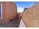 Side yard of home featuring a gravel walkway and desert landscaping at 15774 W Indianola Dr # Six, Goodyear, AZ 85395