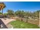 Relaxing backyard patio featuring stone flooring, seating, artificial turf, and desert landscaping at 17323 E Teal Dr, Fountain Hills, AZ 85268