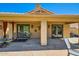 Back patio with stone flooring, desert landscaping, glass sliding doors and outdoor seating at 17323 E Teal Dr, Fountain Hills, AZ 85268