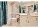 Bright bathroom features a tub/shower combo, large mirror, and a neutral color palette at 17323 E Teal Dr, Fountain Hills, AZ 85268