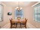 Cozy dining area with a charming chandelier and natural light, perfect for Gathering meals and gatherings at 17323 E Teal Dr, Fountain Hills, AZ 85268