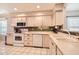 Well-lit kitchen with tiled floors, white appliances, and wooden cabinets at 17323 E Teal Dr, Fountain Hills, AZ 85268