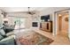 Comfortable living room with a fireplace, sliding glass doors, and tiled floors at 17323 E Teal Dr, Fountain Hills, AZ 85268