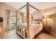 Comfortable bedroom with wooden floors, a four-poster bed, and access to a balcony at 17323 E Teal Dr, Fountain Hills, AZ 85268