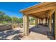 Covered patio featuring stone flooring, wood beam ceiling, decorative columns, and outdoor seating at 17323 E Teal Dr, Fountain Hills, AZ 85268