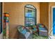 Inviting porch with comfortable seating, a decorative window, and warm lighting at 17323 E Teal Dr, Fountain Hills, AZ 85268