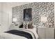 Bedroom features graphic wallpaper, two matching nightstands, and modern lighting at 17749 W Onyx Ave, Waddell, AZ 85355
