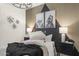 Comfortable bedroom with statement wall, cozy bedding, stylish lamps, and fun dog-themed artwork at 17749 W Onyx Ave, Waddell, AZ 85355