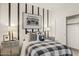 Charming bedroom featuring stylish decor, including a boombox print and striped accent wall at 17749 W Onyx Ave, Waddell, AZ 85355