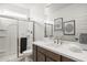 Modern bathroom featuring a glass-enclosed shower and wood vanity at 17755 W Onyx Ave, Waddell, AZ 85355