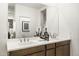 Elegant bathroom featuring a double vanity, sleek fixtures, and modern decorations at 17755 W Onyx Ave, Waddell, AZ 85355
