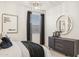 Stylish bedroom featuring modern decor, including a round mirror and chic black drapes at 17755 W Onyx Ave, Waddell, AZ 85355